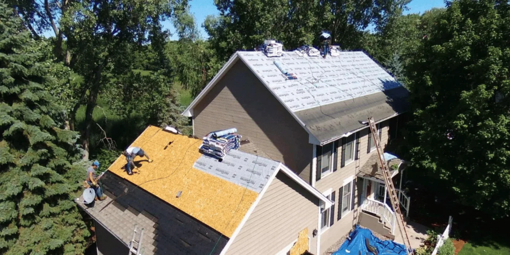 Tony's Roofing installers on top of a roof in Bellevue.